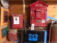 Overview of three fire alarm stations displayed on wooden shelf