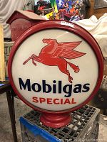 Front view of Mobilgas Special globe on red metal base