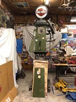 Green metal gas pump body with Harley-Davidson globe topper; internal components visible