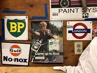 Wall display showing the BP sign, Gulf No-nox sign, vintage Kool Cigarettes metal sign, and partial view of London sign
