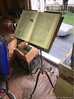 Book stand with open dictionary on top near window, showing size and adjustable top