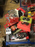 Various Revell die-cast model cars arranged together in original packaging mostly 1:24 scale, including Dale Earnhardt and Havoline themed cars.