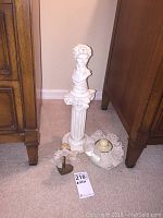 Photo showing the three items together: Roman bust on pedestal, bonnet on stand, and silk container with lace