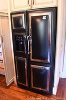 Front view of closed refrigerator/freezer showing four-panel vintage-style doors