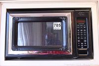 Front view showing decorative stainless steel frame and black housing