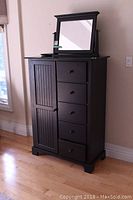 Front view of dark brown dresser with mirror on top
