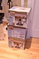 Stacked boxes of Chef Philippe stainless steel chafing dishes, showing packaging and brand logo.