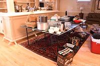 Full view of ping pong table with kitchen and dining items on top, showing the faux wood surface and black metal legs.