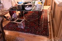 Carpet under table with appliances on top