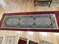 Full view of the hand knotted runner rug laid out on hardwood floor, showing the full length and design.