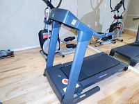 Side view of treadmill showing full frame, belt and handrails