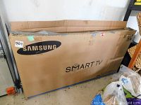 Original Samsung cardboard box labeled SMART TV and Samsung logo, showing intact box with some wear and tear, item sticker 901 visible.