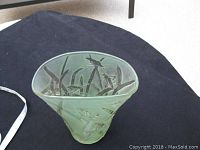 Top view showing the vase's open top and embossed grasshopper motif inside.