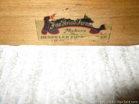 Close-up photo of the maker's label inside the table drawer, reading 'Fine Period Furniture, Makers, Hespeler Furniture Co'