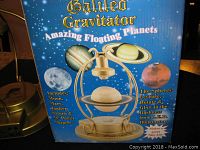 Box showing image of the Galileo Gravitator with planet spheres including Moon, Mars, Jupiter, Saturn and description of floating/levitating feature.
