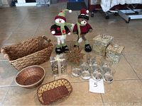 Photo showing all items in the lot including standing bear and snowman, baskets, star, boxes, glasses and guest card holders arranged together.