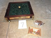 Full view of board game, tiger figurine, and miniature painting on tile floor