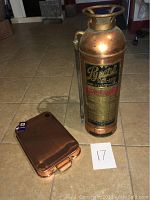 Copper Pyrene soda-acid fire extinguisher with detailed engraved label and handle.