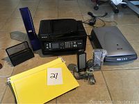 Full lot showing printer, scanner, speakers, folders, and office accessories arranged on floor with tags.