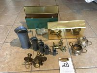Full lot photo showing 5 pewter pitchers, 2 brass mailboxes, brass sugar bowl, creamer, and double candle holder.