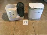 Photo of Honeywell humidifier and Towel Spa towel warmer side by side on tiled floor with lot number label.