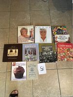 Overview of 10 books including historical, cooking, and lifestyle titles spread on floor.