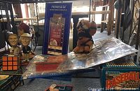 Overview of baseball cards, bobble heads, puzzle cards, Rubik's Cube, plush tiger, and framed All-Star Game ticket.