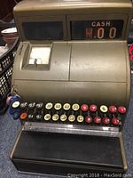 Full front view of the antique cash register showing keys, keyslot, and display window with 'CASH' amount showing zero