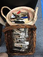 Two wicker baskets, one containing various folding pocket knives, one basket containing wrapped presidential collectible knives with portraits and names of U.S. presidents.