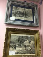 Both framed Civil War ink prints hanging on wall, one in a distressed gray wood frame, the other in a gold ornate frame