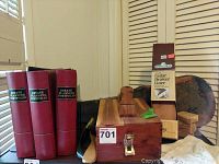 Various items including a wooden shoe shine box, estate planning portfolios, cedar drawer liner, and miscellaneous boxes