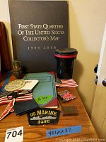 Collector's Map and various patches, flags, container, and other items arranged on wood table