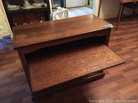 Front view of wooden bookshelf showing open shelf and lower solid panel base with visible wood grain.