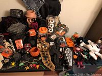 Overview of Halloween decor items showing various props including skeletons, pumpkins, witch hats, stuffed toys, and novelty items.