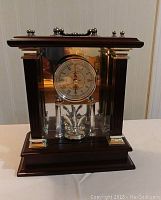 Front view of Wallace quartz mantle clock showing wooden case, chrome accents and clock face.