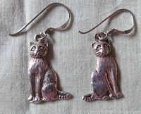 Front view of vintage sterling silver cat earrings showing detailed cat faces and textured fur.