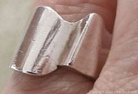 Close-up view of the top of the vintage sterling silver modernist ring showing the wave design and polished silver surface.