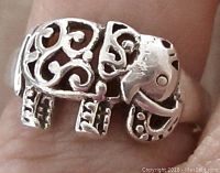 Close-up frontal view of the elephant design on the sterling silver ring, showing detailed pierced scrollwork and tribal style elements.