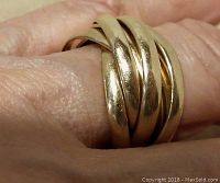 Close-up photo showing the ring worn on a finger to illustrate size and appearance