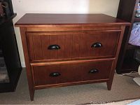 Front view of the wooden dresser showing two deep drawers and black handles.
