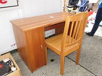 Desk and wooden chair shown from the front and side angles, highlighting the wood grain finish, drawer handles, and chair slats.