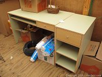 Full view of the green and wood veneer MDF computer desk with central drawer and open shelf underneath, showing surface and condition.