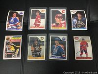 Front view of select hockey cards including key rookie cards of Mario Lemieux and Al MacInnis, alongside Wayne Gretzky, Steve Yzerman, Mark Messier, Doug Gilmour and Chris Chelios cards.