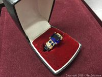 Ring displayed in presentation box on red velvet insert