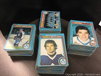 Three stacks of vintage 1979-80 O-Pee-Chee hockey cards, front cards include Borje Salming Toronto Maple Leafs All-Star, Mike Palmateer Toronto Maple Leafs, New York Islanders cards.