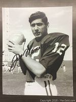 Black and white 16x20 inch print of Joe Namath holding a football in uniform with facsimile autograph.