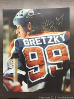 16x20 glossy photograph showing Wayne Gretzky wearing Edmonton Oilers number 99 jersey with facsimile autograph.