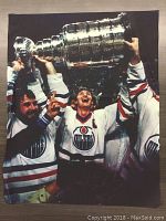 Image of canvas nylon print depicting Wayne Gretzky and teammates holding Stanley Cup, wearing Edmonton Oilers jerseys, includes facsimile autograph.