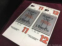 Two 1986 Stanley Cup Playoff tickets for Philadelphia Flyers home games in seats 11 and 12, section L 20, row 16 shown on a flat surface.