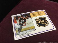 Front of 1981 Wayne Gretzky O-Pee-Chee hockey card showing player image, NHL logo, and text about assist leader status.